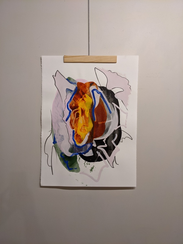 A photograph of an abstract acrylic painting on a white background. The painting is many colors swirled together, with no defined shape or pattern. The center is swirled orange and red, bordered by patches of pale pink and green. There are black and blue accent lines throughout.